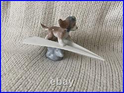 Lladro 6665 Let's Fly Away - Puppy withgoggles flying on a paper airplane