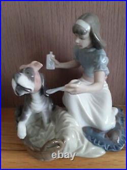 Lladro. Girl giving her dog medication Take your medication No. 5921