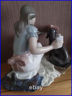 Lladro. Girl giving her dog medication Take your medication No. 5921