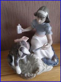 Lladro. Girl giving her dog medication Take your medication No. 5921