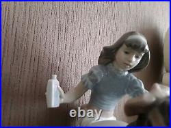 Lladro. Girl giving her dog medication Take your medication No. 5921