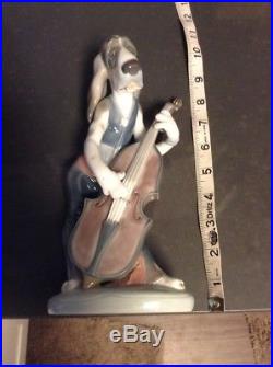 Lladro dog playing bass fiddle