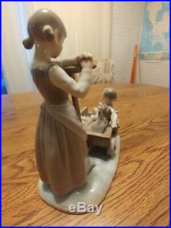 Lladro figurine girl with dog in cart. No flaws no box