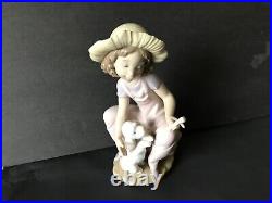 Lladro girl giving her dog a bone. 7 in. Tall. Excellent condition