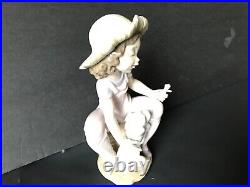 Lladro girl giving her dog a bone. 7 in. Tall. Excellent condition