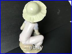 Lladro girl giving her dog a bone. 7 in. Tall. Excellent condition