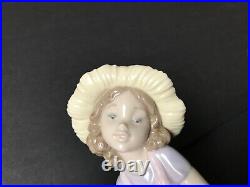 Lladro girl giving her dog a bone. 7 in. Tall. Excellent condition