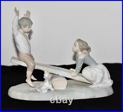 NAO Lladro Spain Large Bisque Porcelain Boy and Girl on Seesaw with Dog