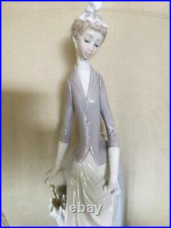 Retired Lladro figurine. Lady with umbrella and dog