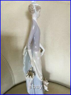 Retired Lladro figurine. Lady with umbrella and dog